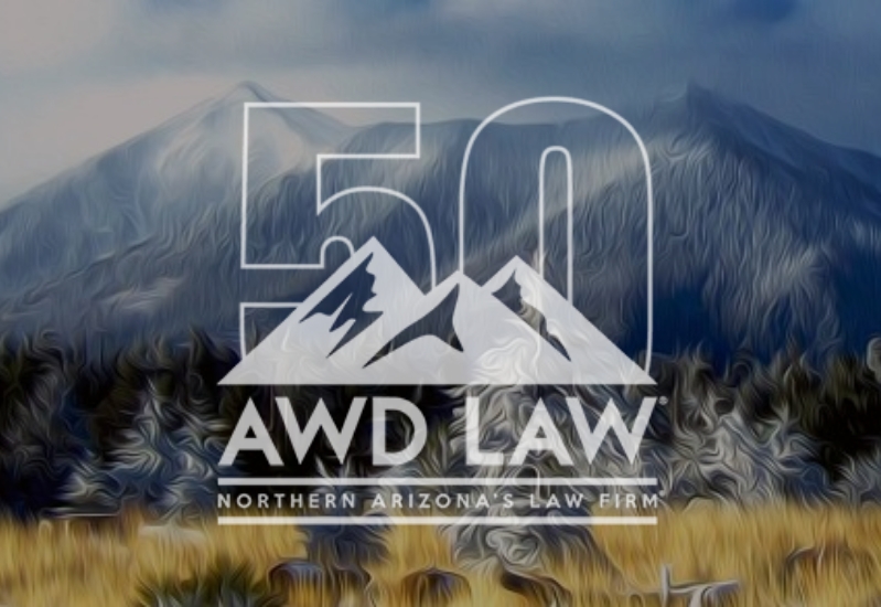 Sharp AWD Law 50th logo with snowy trees and peaks