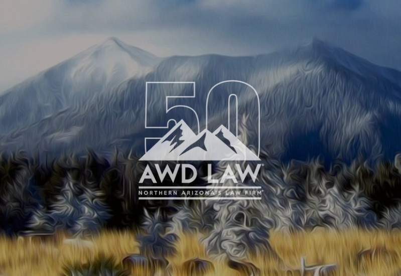 AWD Law 50th logo over clear mountain view